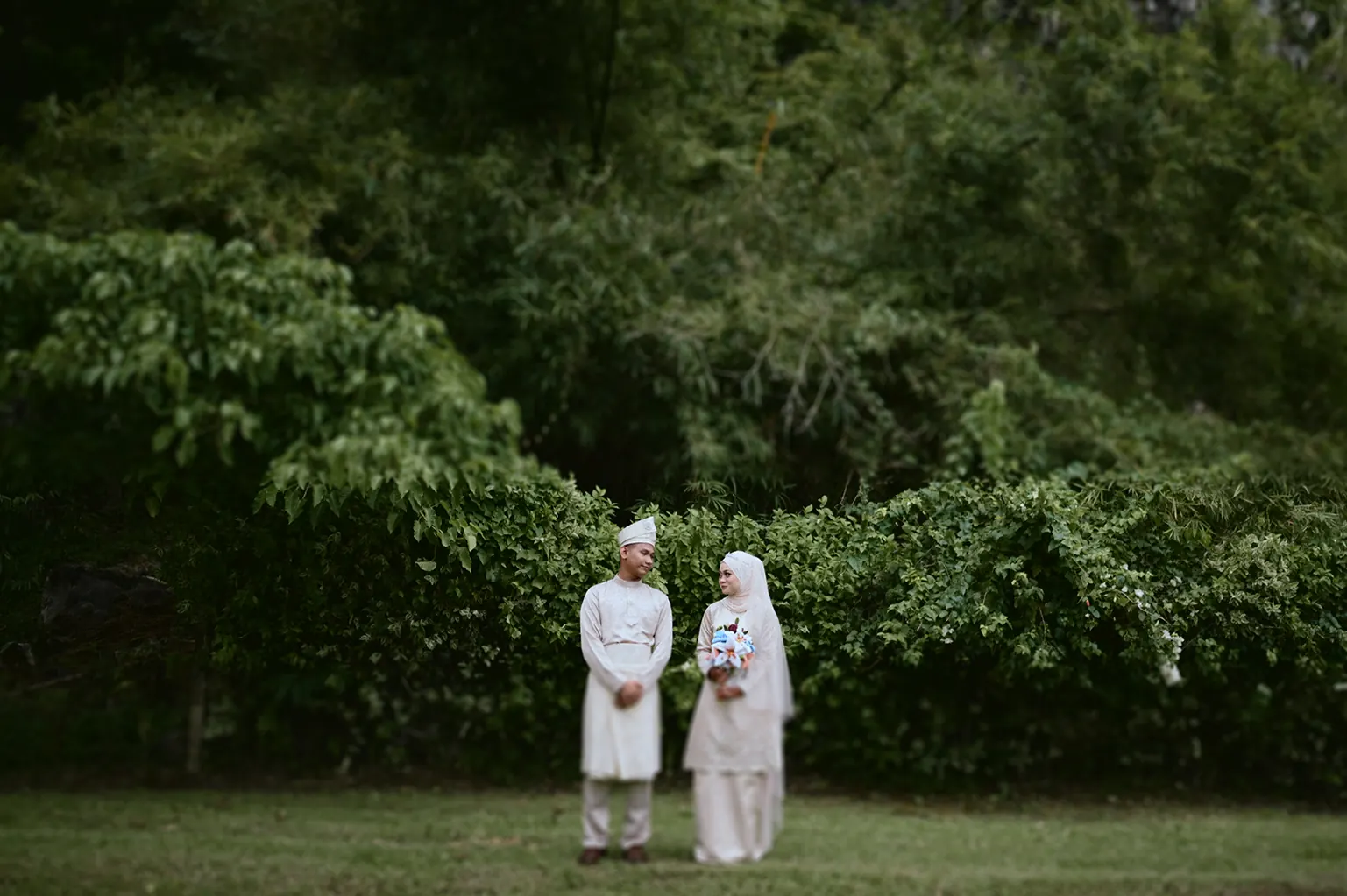 Malay wedding couple sharing a quiet smile